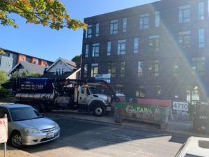 flow tech truck parked on street in front of building